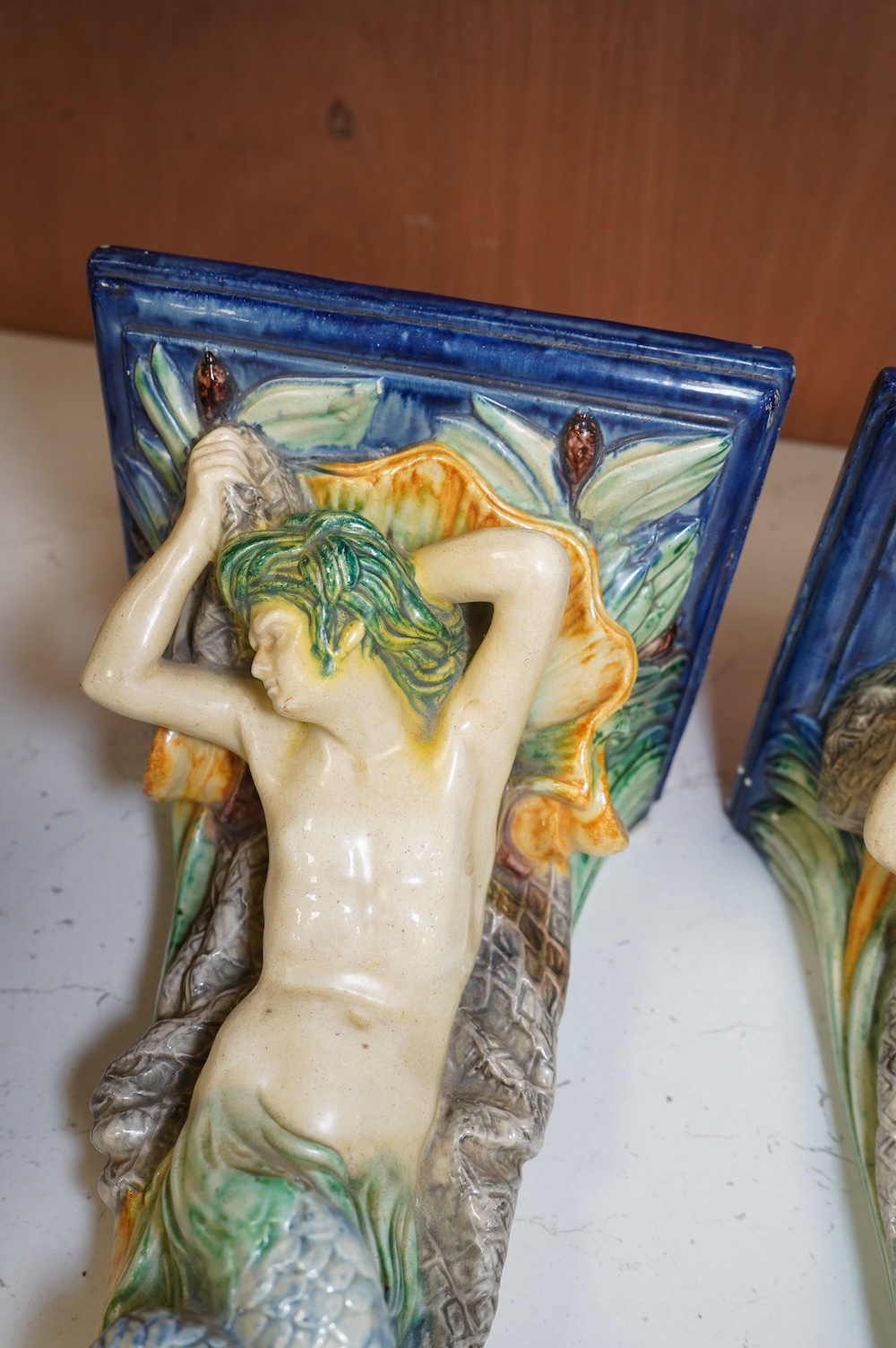 A pair of late 19th century Continental majolica ‘mer people’ wall brackets, 30cm. Condition - fair to good